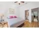 Comfortable bedroom showcasing a ceiling fan and access to an ensuite bathroom at 297 Countryside Key Blvd, Oldsmar, FL 34677