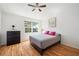 Cozy bedroom with a large window and ceiling fan, offering a relaxing retreat at 297 Countryside Key Blvd, Oldsmar, FL 34677