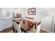 Dining room area featuring a wooden table, seating for six, and kitchen view at 297 Countryside Key Blvd, Oldsmar, FL 34677