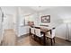Dining area with open layout, featuring wooden floors, a modern light fixture, and white walls at 297 Countryside Key Blvd, Oldsmar, FL 34677