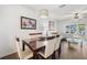 Dining room with wood floors and an open-concept layout leading to the living room and kitchen at 297 Countryside Key Blvd, Oldsmar, FL 34677