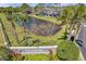 Inviting entrance to Countryside Key, showcased by lush greenery, a serene pond, and well-manicured landscaping at 297 Countryside Key Blvd, Oldsmar, FL 34677