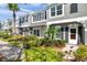 Charming townhome with gray stucco, black shutters, and professionally landscaped front yard at 297 Countryside Key Blvd, Oldsmar, FL 34677
