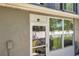 Exterior of the patio featuring a door and windows that offer a view to the well-maintained backyard at 297 Countryside Key Blvd, Oldsmar, FL 34677