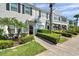 Townhome exterior exhibiting grey stucco, black shutters, and well-manicured lawns at 297 Countryside Key Blvd, Oldsmar, FL 34677