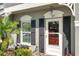 Close-up of a home's front entrance showing decorative trim, and black shutters at 297 Countryside Key Blvd, Oldsmar, FL 34677
