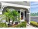 Front door showcasing white trim, decorative windows, and manicured landscaping at 297 Countryside Key Blvd, Oldsmar, FL 34677