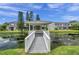 Scenic gazebo view with water features, lush landscaping, and inviting community ambiance under a bright, cloudy sky at 297 Countryside Key Blvd, Oldsmar, FL 34677