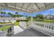 Charming gazebo interior with seating overlooking a serene water feature, complemented by landscaped grounds and community amenities at 297 Countryside Key Blvd, Oldsmar, FL 34677
