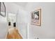 Bright hallway with wood floors, a white railing, and artwork adding a personal touch at 297 Countryside Key Blvd, Oldsmar, FL 34677