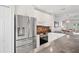Modern kitchen featuring stainless steel appliances, granite counters, and white cabinets at 297 Countryside Key Blvd, Oldsmar, FL 34677