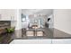 Modern kitchen featuring a stainless steel sink, granite countertops, and a view of the dining area at 297 Countryside Key Blvd, Oldsmar, FL 34677