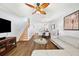 Bright living room with wood floors, ceiling fan, and a staircase leading to the upper level at 297 Countryside Key Blvd, Oldsmar, FL 34677
