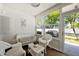 Enclosed patio with white wicker furniture and a ceiling fan at 297 Countryside Key Blvd, Oldsmar, FL 34677