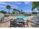 A beautiful community pool with a dining table, plenty of lounge chairs and lush landscaping, ideal for outdoor gatherings at 297 Countryside Key Blvd, Oldsmar, FL 34677