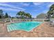 A luxurious community pool surrounded by comfortable lounge chairs and lush landscaping, perfect for relaxation at 297 Countryside Key Blvd, Oldsmar, FL 34677