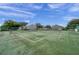 Tennis court with well-maintained green surface, perfect for enjoying a game in a serene setting at 297 Countryside Key Blvd, Oldsmar, FL 34677