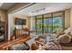 Sunny balcony with glass doors and seating, offering lovely treetop views at 3076 Eastland Blvd # 305, Clearwater, FL 33761