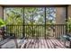 Inviting balcony with wrought iron railing providing serene view of lush green trees at 3076 Eastland Blvd # 305, Clearwater, FL 33761