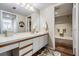 Bright bathroom with a shower-tub combo, wooden floors, ample countertop space and well-lit vanity mirror at 3076 Eastland Blvd # 305, Clearwater, FL 33761