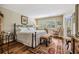 Cozy bedroom with hardwood floors, shuttered windows, and a rocking chair by a side door at 3076 Eastland Blvd # 305, Clearwater, FL 33761