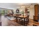 Dining room open to living room featuring wood floors and chandelier at 3076 Eastland Blvd # 305, Clearwater, FL 33761