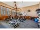 Exercise room with many windows, wood paneling and multiple work out machines including ellipticals and bikes at 3076 Eastland Blvd # 305, Clearwater, FL 33761