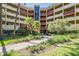 Exterior view of building with lush greenery and mature landscaping at 3076 Eastland Blvd # 305, Clearwater, FL 33761