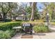 Outdoor grill area with a propane grill and table, surrounded by lush landscaping at 3076 Eastland Blvd # 305, Clearwater, FL 33761