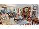 Elegant living room features hardwood floors and a dining area with a chandelier and a round mirror at 3076 Eastland Blvd # 305, Clearwater, FL 33761