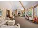 Spacious living room featuring a fireplace, large windows, neutral color palette, and comfortable seating at 3076 Eastland Blvd # 305, Clearwater, FL 33761