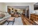 Spacious living room with hardwood floors, comfortable seating, and a view of the dining area at 3076 Eastland Blvd # 305, Clearwater, FL 33761
