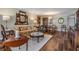Cozy living room with hardwood floors, patterned sofa, and dining area in the background at 3076 Eastland Blvd # 305, Clearwater, FL 33761