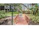 Tree-lined walkway with mature trees, a small bridge and lush landscaping at 3076 Eastland Blvd # 305, Clearwater, FL 33761