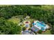 Scenic aerial view of the community featuring a pool, playground, dog park and pond surrounded by mature landscaping at 3226 Cordoba Ranch Blvd, Lutz, FL 33559