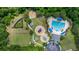 Aerial view of the community pool, playground, dog park, picnic area, and pond, nestled among mature trees and landscaping at 3226 Cordoba Ranch Blvd, Lutz, FL 33559