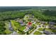 Aerial view of the home nestled in a lush, green neighborhood near a tranquil pond at 3226 Cordoba Ranch Blvd, Lutz, FL 33559