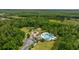 Aerial view of community pool, playground and common area surrounded by lush green landscape on a bright, sunny day at 3226 Cordoba Ranch Blvd, Lutz, FL 33559