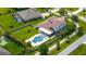Aerial view of a home with a large backyard, pool, patio, and basketball court at 3226 Cordoba Ranch Blvd, Lutz, FL 33559