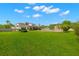 Spacious back yard with lush green grass, a covered patio, a pergola, and a privacy fence at 3226 Cordoba Ranch Blvd, Lutz, FL 33559