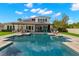 Large backyard with swimming pool, patio, outdoor kitchen, and green grass at 3226 Cordoba Ranch Blvd, Lutz, FL 33559
