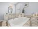Luxurious bathroom featuring a soaking tub, double sinks, and granite countertops at 3226 Cordoba Ranch Blvd, Lutz, FL 33559