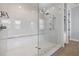 Spacious glass shower features white marble-style tile, rainfall shower head and built in bench at 3226 Cordoba Ranch Blvd, Lutz, FL 33559