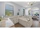 Luxurious bathroom featuring a soaking tub, double sinks, and granite countertops at 3226 Cordoba Ranch Blvd, Lutz, FL 33559