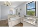 Luxurious bathroom featuring a soaking tub, double sinks, and granite countertops at 3226 Cordoba Ranch Blvd, Lutz, FL 33559