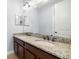 Bathroom with granite countertop, double sink, dark cabinets, and large, framed mirror at 3226 Cordoba Ranch Blvd, Lutz, FL 33559
