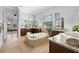 Bright bathroom with a soaking tub, dual sinks, granite countertops, wooden cabinetry, and large mirrors at 3226 Cordoba Ranch Blvd, Lutz, FL 33559