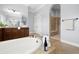 Bathroom with a walk-in shower, granite countertops, a standalone tub, and wood cabinetry at 3226 Cordoba Ranch Blvd, Lutz, FL 33559