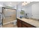 Bathroom featuring granite countertops, modern vanity, walk-in shower, and neutral tile flooring at 3226 Cordoba Ranch Blvd, Lutz, FL 33559