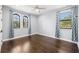 Sunlit bedroom with beautiful dark wood floors, blue accent walls, and decorative window treatments at 3226 Cordoba Ranch Blvd, Lutz, FL 33559
